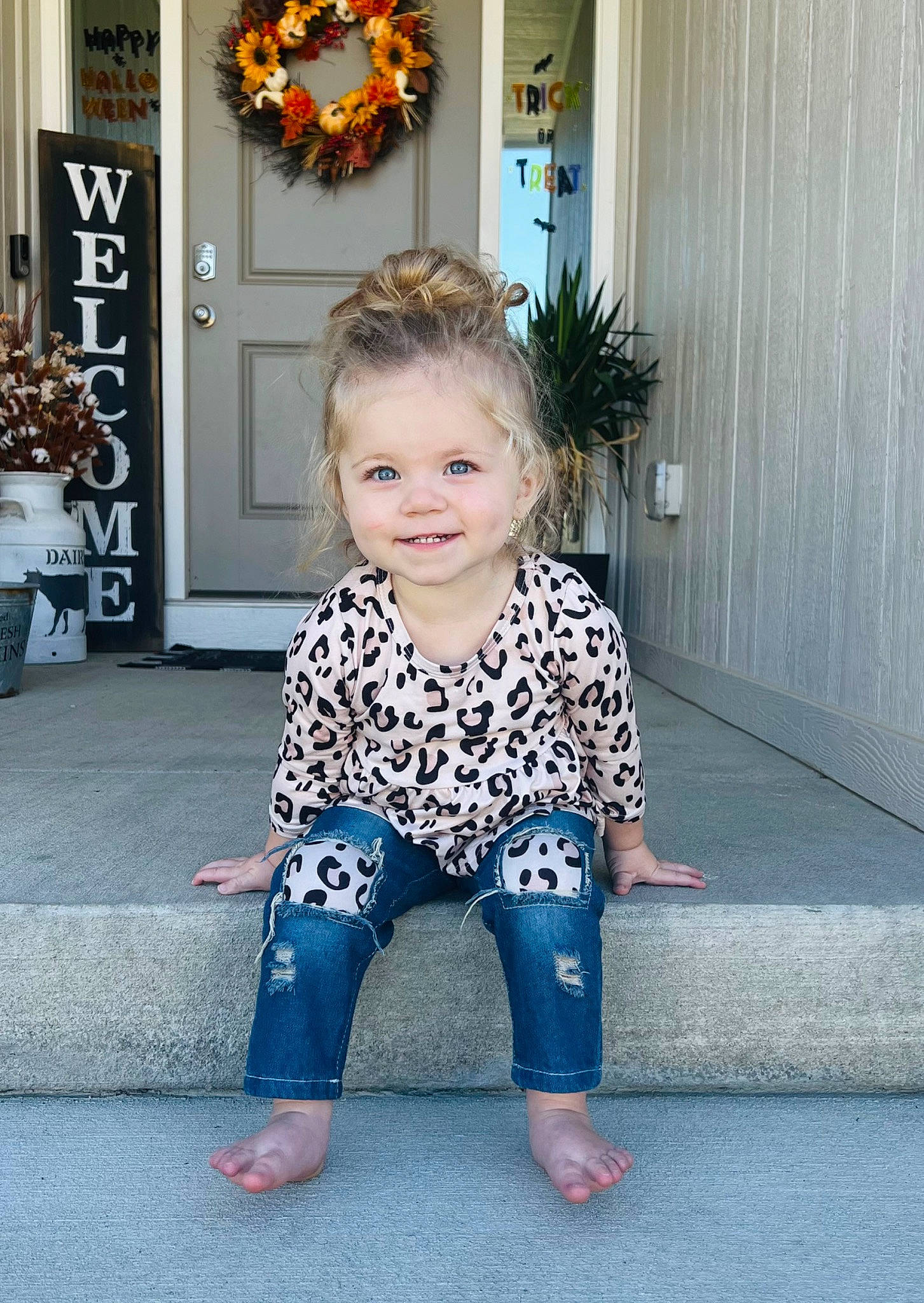 Sloane is registered to the contest to win money with this photo: baby_toddler_clothing, barefoot, child, denim, door, electric_blue, floor, flooring, foot, fun, grass, happy, joy, pattern, person, picture_frame, plant, sitting, sleeve, smile