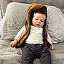 Lían Steven joined the competition — help win amazing prizes! baby, bed, pillow, striped_pillow, hoodie, vest, clothing, infant, person, cute, relaxed, indoors, sleepwear, soft_texture, portrait, sitting, young_child, cozy, blanket, casual