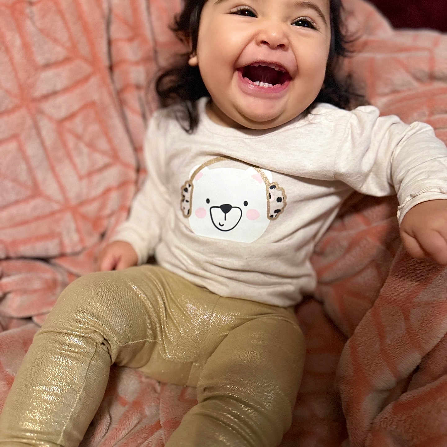 Aimee Sue is registered to the contest to win money with this photo: bear_design, black_hair, blanket, cheerful, child, clothing, cozy, cute, fabric, face, happy, indoors, leggings, person, portrait, shirt, sitting, smiling, texture, toddler