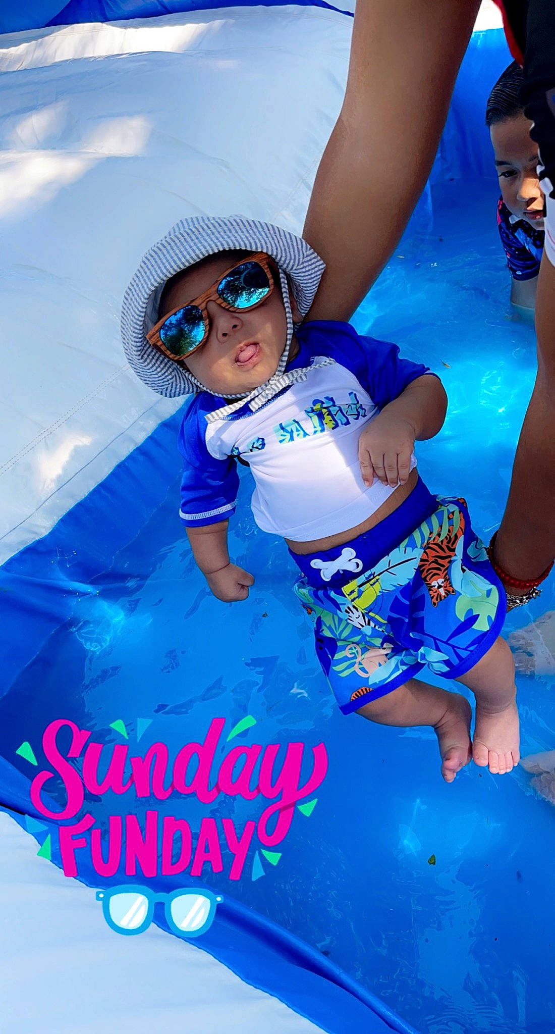 Princeton is registered to the contest to win money with this photo: aqua, azure, baby_toddler_clothing, blue, electric_blue, eyewear, fun, gesture, glove, goggles, happy, hat, headwear, human_leg, leisure, person, personal_protective_equipment, play, recreation, sunglasses