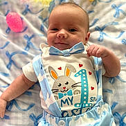 Hudson joined the competition — help win amazing prizes! baby, infant, smile, blue_clothing, bow_tie, easter, easter_eggs, blanket, patterned_blanket, cute_outfit, baby_girl, baby_boy, lying_down, celebration, happy, face, small_hand, indoors, soft_light, portrait