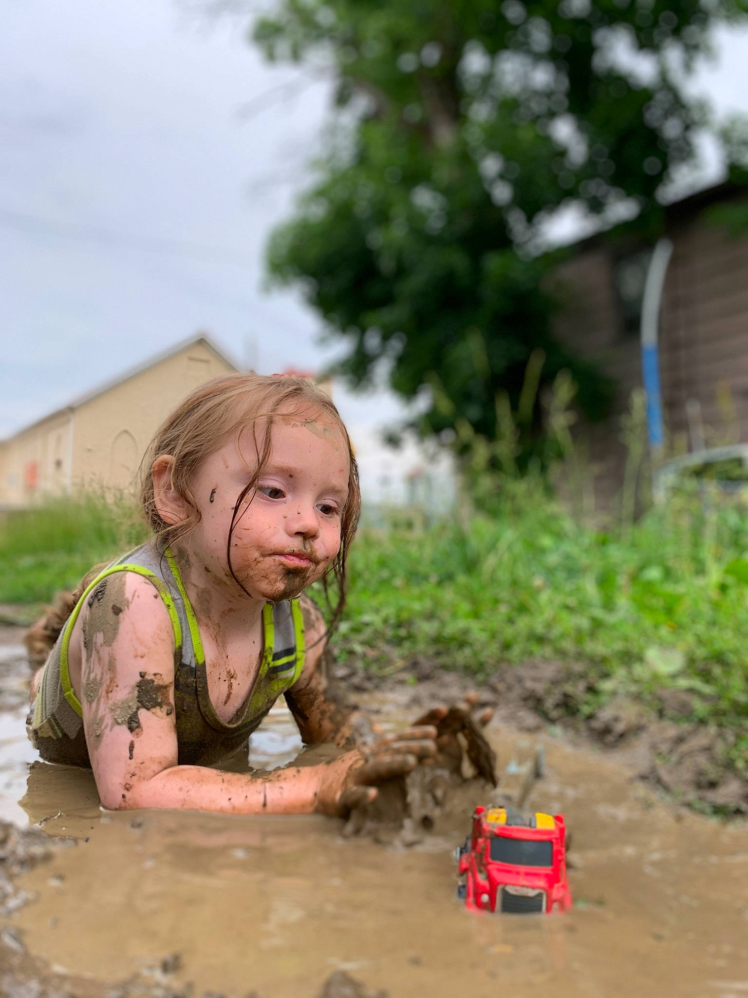 Bubba joined the competition — help win amazing prizes! asphalt, automotive_tire, child, fun, grass, landscape, machine, person, plant, play, recreation, sitting, sky, soil, tire, toddler, toy, toy_vehicle, tree, wheel