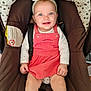 baby, blue_eyes, car_seat, child, clothing, cute, face, hands, happy, headband, indoor, infant, legs, person, pink_dress, portrait, seatbelt, sitting, smiling, young_child