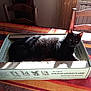 Louna participe au concours pour gagner de l'argent avec cette photo : black, black_cat, box, cat, cat_like_mammal, flooring, fur, furniture, small_to_medium_sized_cats, whiskers, wood