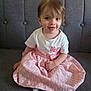 Mackenzie participe au concours pour gagner de l'argent avec cette photo : toddler, child, smiling, dress, pink, white, couch, indoor, person, sitting, happy, cute, hair, face, sock, clothing, furniture, portrait, young_child, cozy