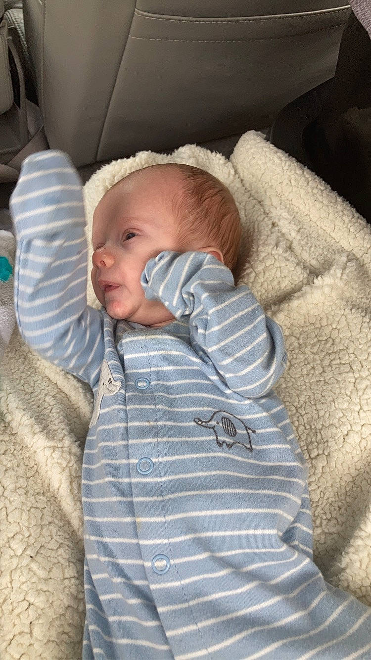 Chess is registered to the contest to win money with this photo: baby, baby_toddler_clothing, cheek, child, chin, comfort, face, finger, head, iris, linens, mammal, mouth, nose, person, sitting, skin, sleeve, textile, toddler