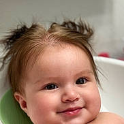 Chloe is registered to the contest to win money with this photo: baby, child, face, smile, cheeks, hair, pigtails, skin, portrait, infant, cute, expression, head, closeup, childhood, young, sitting, indoors, person, happy