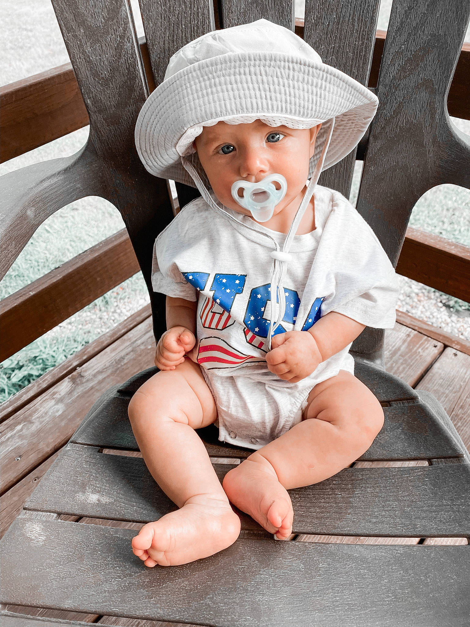 Fletcher is registered to the contest to win money with this photo: baby, baby_toddler_clothing, barefoot, beauty, cap, chair, child, comfort, electric_blue, face, foot, headwear, human_leg, knee, people, person, shorts, sitting, sleeve, sun_hat