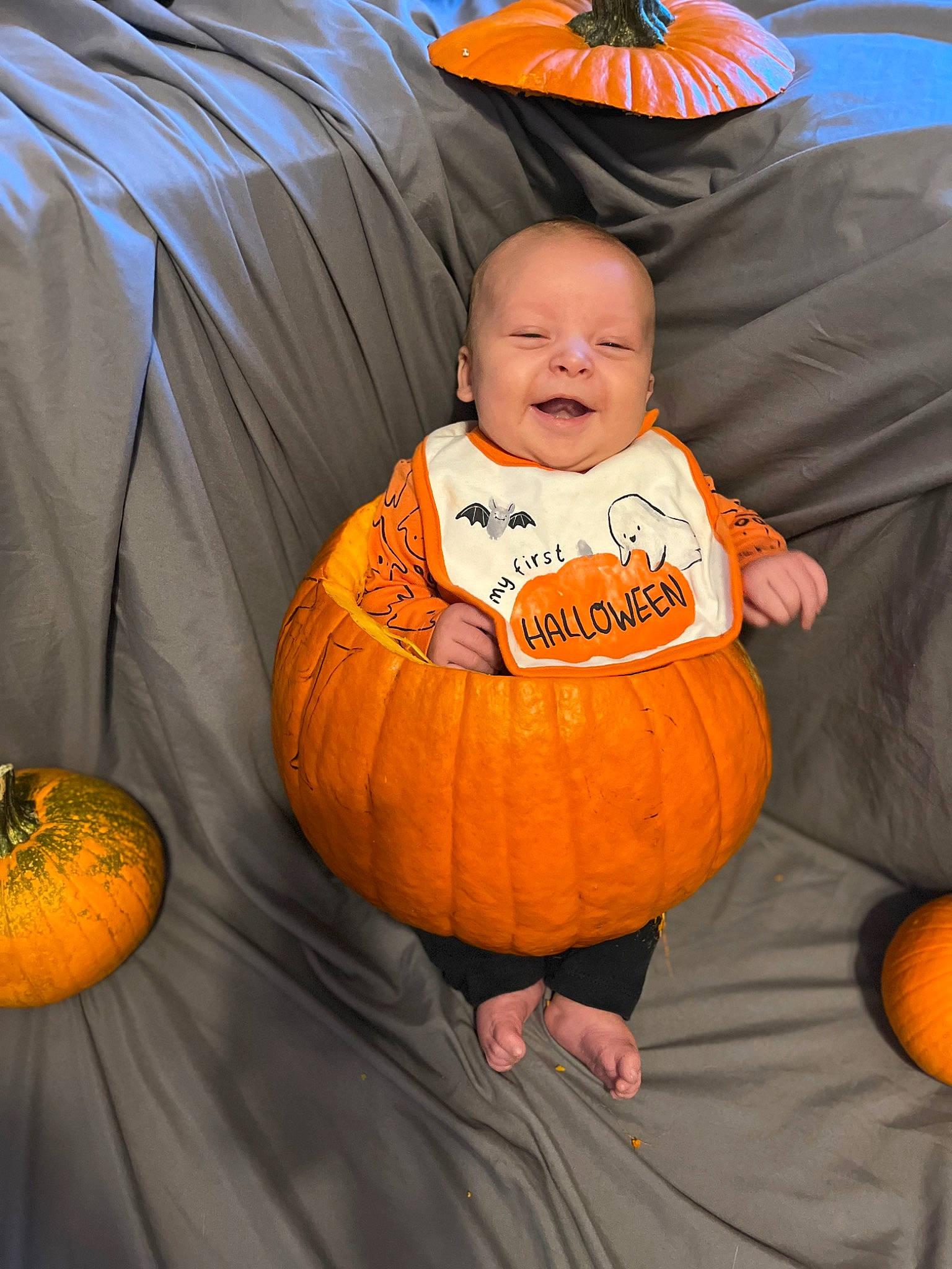 Odin is registered to the contest to win money with this photo: baby_toddler_clothing, calabaza, comfort, cucurbita, eye, face, flooring, gourd, head, human_body, leaf, orange, person, plant, pumpkin, squash, tree, vegetable, winter_squash, wood