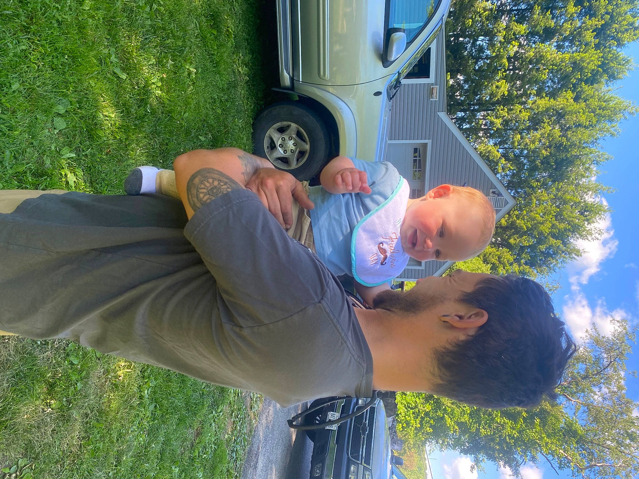 Deegan joined the competition — help win amazing prizes! automotive_tire, blue, fun, grass, green, happy, hat, leg, leisure, light, motor_vehicle, person, photograph, plant, sky, tire, tree, vehicle, vehicle_door, wheel