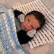 Nirvana joined the competition — help win amazing prizes! newborn, baby, blanket, crochet, pillow, mittens, face, infant, lying_down, striped_clothing, bed, soft, cute, indoors, portrait, sleeping_area, cozy, tiny_hands, resting, young_child