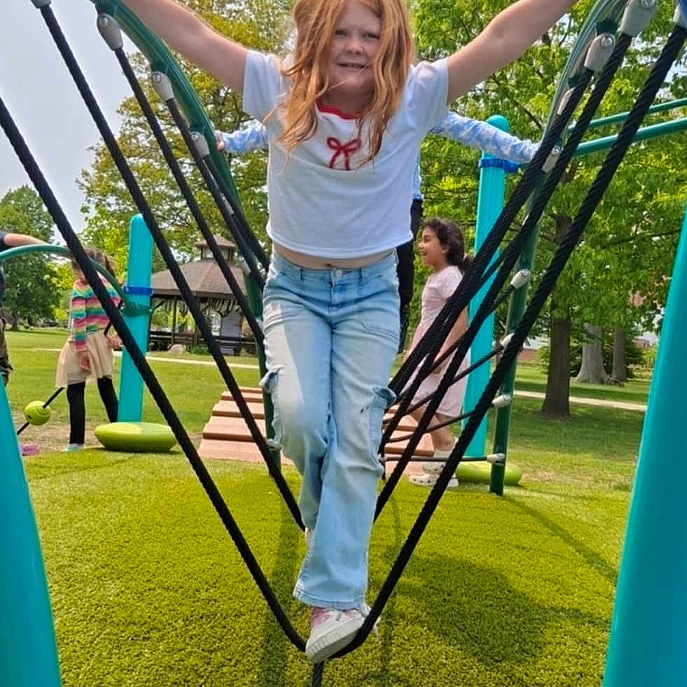 Hailie Princess Kilbourne is registered to the contest to win money with this photo: blue_jeans, casual_clothing, child, daylight, friends, fun, grass, greenery, happy, kids, outdoor, park, play, playground, recreation, rope_bridge, sneakers, summer, trees, white_shirt