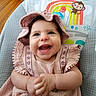 baby, child, smiling, pink_dress, hat, baby_chair, rainbow, monkey, sun, indoor, wooden_floor, happy, cute, portrait, infant, clothing, colorful, playful, hands, seat