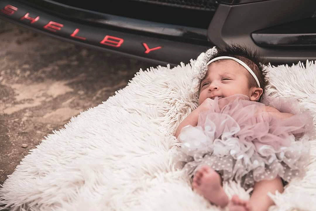 Shelby is registered to the contest to win money with this photo: automotive_design, automotive_lighting, baby, baby_toddler_clothing, bridal_accessory, bridal_clothing, bridal_party_dress, comfort, dress, embellishment, flash_photography, gown, happy, headpiece, iris, person, personal_luxury_car, petal, smile, toddler