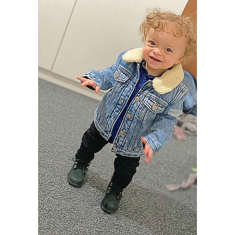 Kyran is registered to the contest to win money with this photo: baby_toddler_clothing, clothing, collar, denim, dress, electric_blue, face, fashion_design, footwear, gesture, happy, headgear, outerwear, person, shoe, sleeve, smile, sportswear, street_fashion, toddler