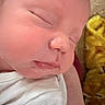 Elijah is registered to the contest to win money with this photo: newborn, baby, infant, sleeping, close_up, portrait, face, eyes_closed, nose, mouth, cheeks, skin, white_clothing, blanket, plush, yellow, cozy, indoors, candid, cute