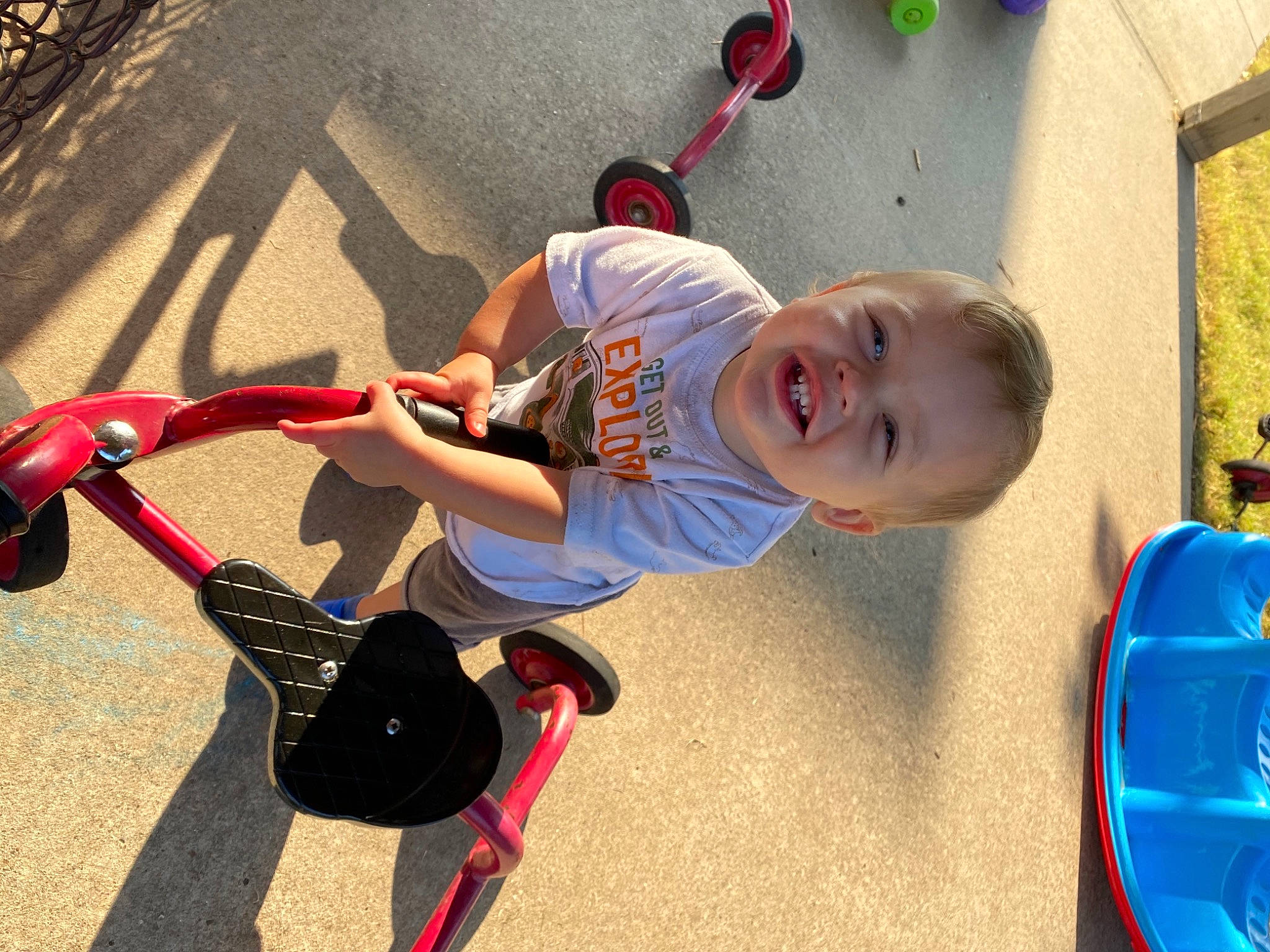 Clyde is registered to the contest to win money with this photo: automotive_tire, bicycle_handlebar, bicycle_tire, blue, child, electric_blue, fun, happy, joint, kick_scooter, knee, person, recreation, rolling, shorts, smile, t_shirt, tire, toddler, toy