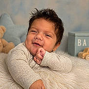 David is registered to the contest to win money with this photo: baby, infant, smiling, cute, teddy_bear, toy_car, fluffy_blanket, nursery, soft_lighting, portrait, child, indoors, cozy, happy, person, cute_expression, small_hands, warm_colors, background_objects, relaxed
