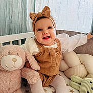Alma-Maria a rejoint le concours — aidez-le/la à gagner de superbes lots ! baby, child, smiling, headband, bow, corduroy, plush_toy, bunny, crib, blanket, tights, happy, indoors, soft_light, curtains, cute, infant, person, toy, seated