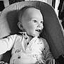 baby, child, smile, happy, face, portrait, cushion, seated, clothing, indoor, black_and_white, cute, infant, eyes, expression, comfort, young, person, seat, joy