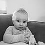 Nino a rejoint le concours — aidez-le/la à gagner de superbes lots ! baby, infant, child, toy, couch, indoors, portrait, black_and_white, cute, hands, sitting, sweater, looking_at_camera, soft_light, home, furniture, expression, face, young, cozy