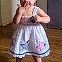 Jade is registered to the contest to win money with this photo: toddler, child, dress, white_dress, stars, barefoot, wooden_floor, indoors, smiling, cute, playful, person, young_child, standing, floor, light_hair, skin, happy, hand, portrait