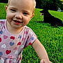 Jade is registered to the contest to win money with this photo: toddler, child, smiling, outdoor, grass, dog, black_dog, greenery, happy, cute, nature, person, baby, casual_clothing, short_sleeves, daylight, portrait, hand, jeans, playing