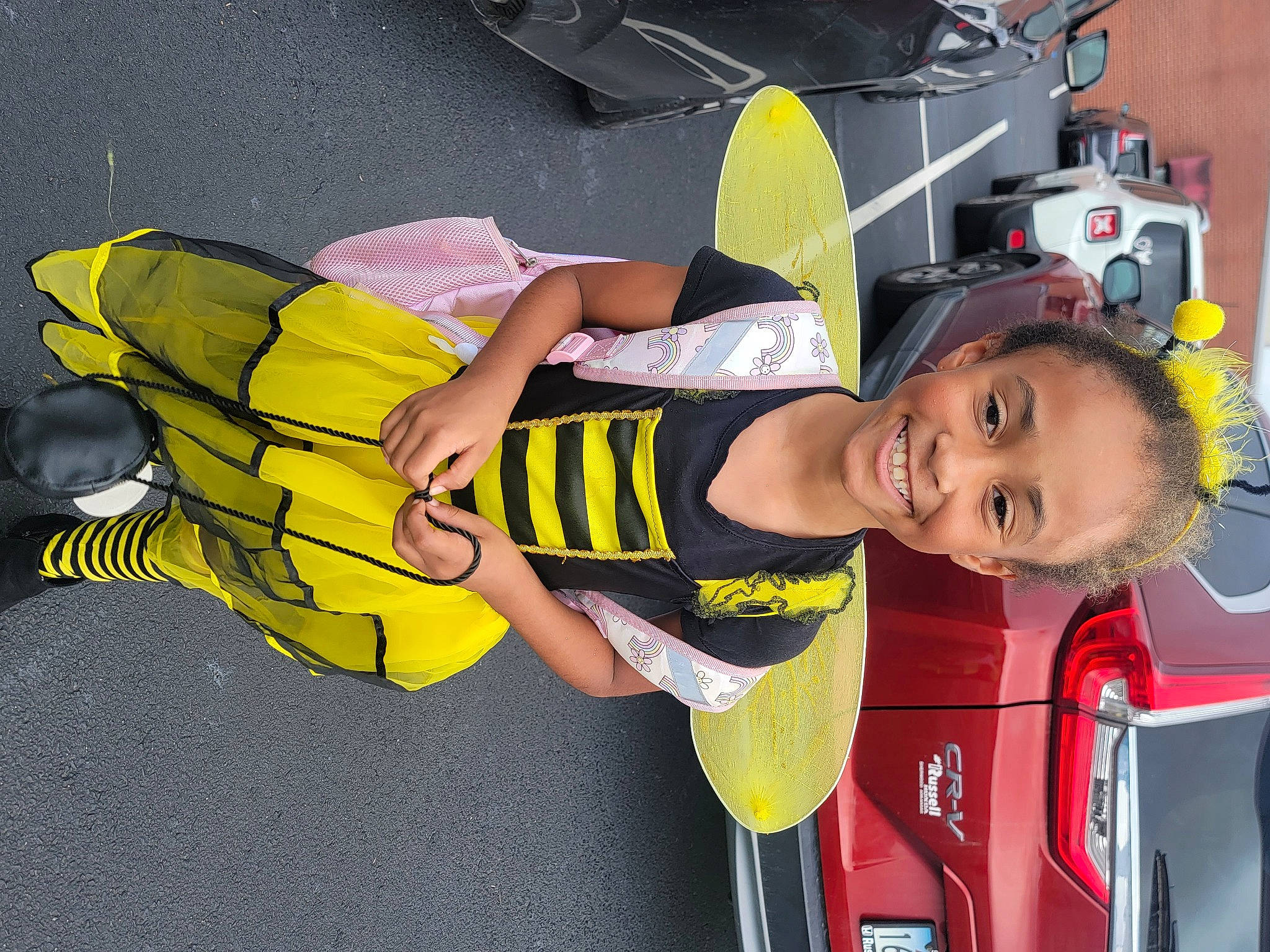 Journi is registered to the contest to win money with this photo: automotive_exterior, child, family_car, fictional_character, fun, joy, leisure, motor_vehicle, person, personal_protective_equipment, recreation, shorts, smile, t_shirt, thigh, tire, toddler, vehicle, vehicle_door, yellow