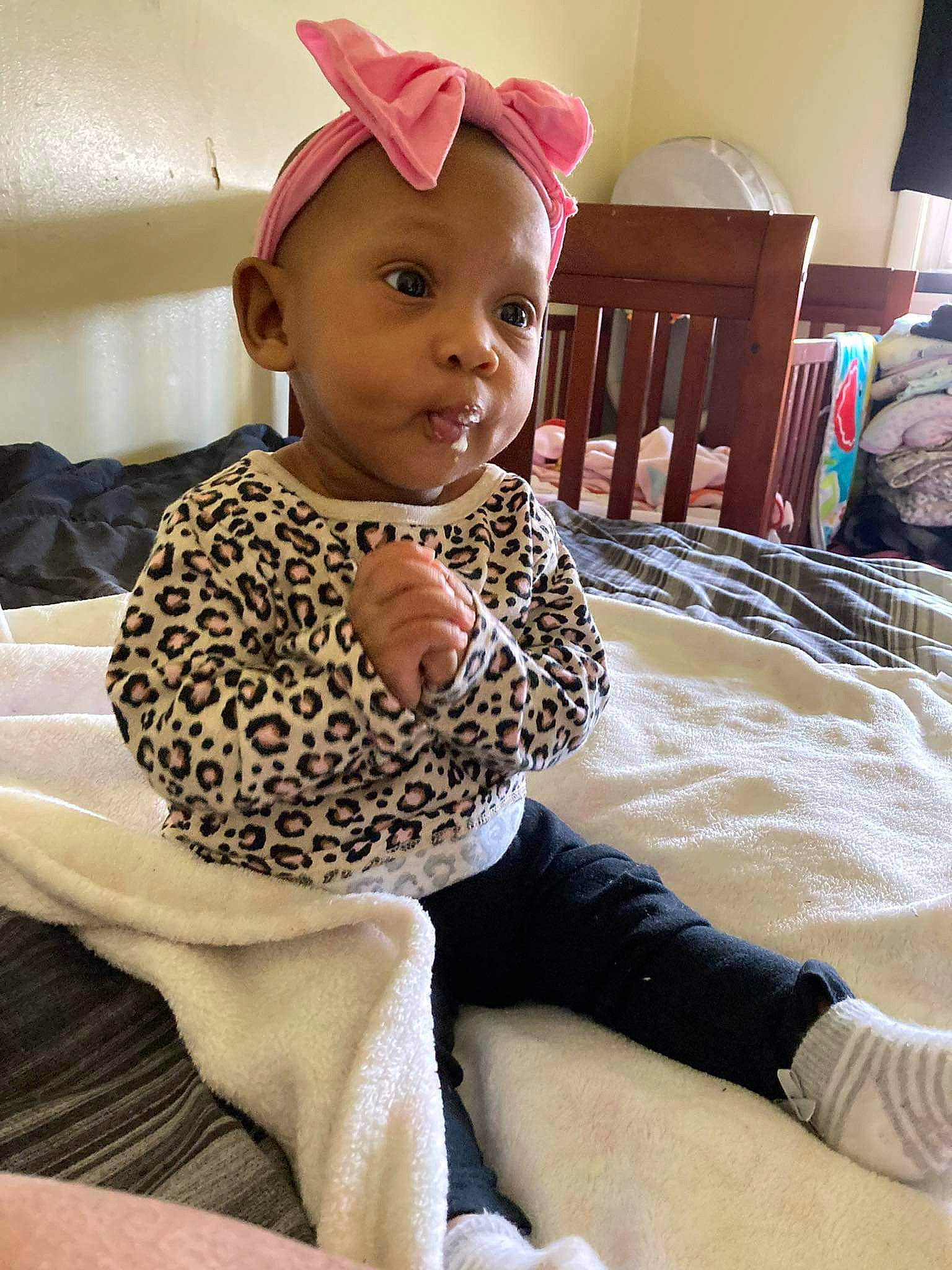 Samiyah joined the competition — help win amazing prizes! baby, baby_toddler_clothing, cap, child, comfort, fashion_accessory, flooring, fun, happy, human_leg, knee, lamp, leisure, pattern, person, room, sitting, sleeve, smile, thigh