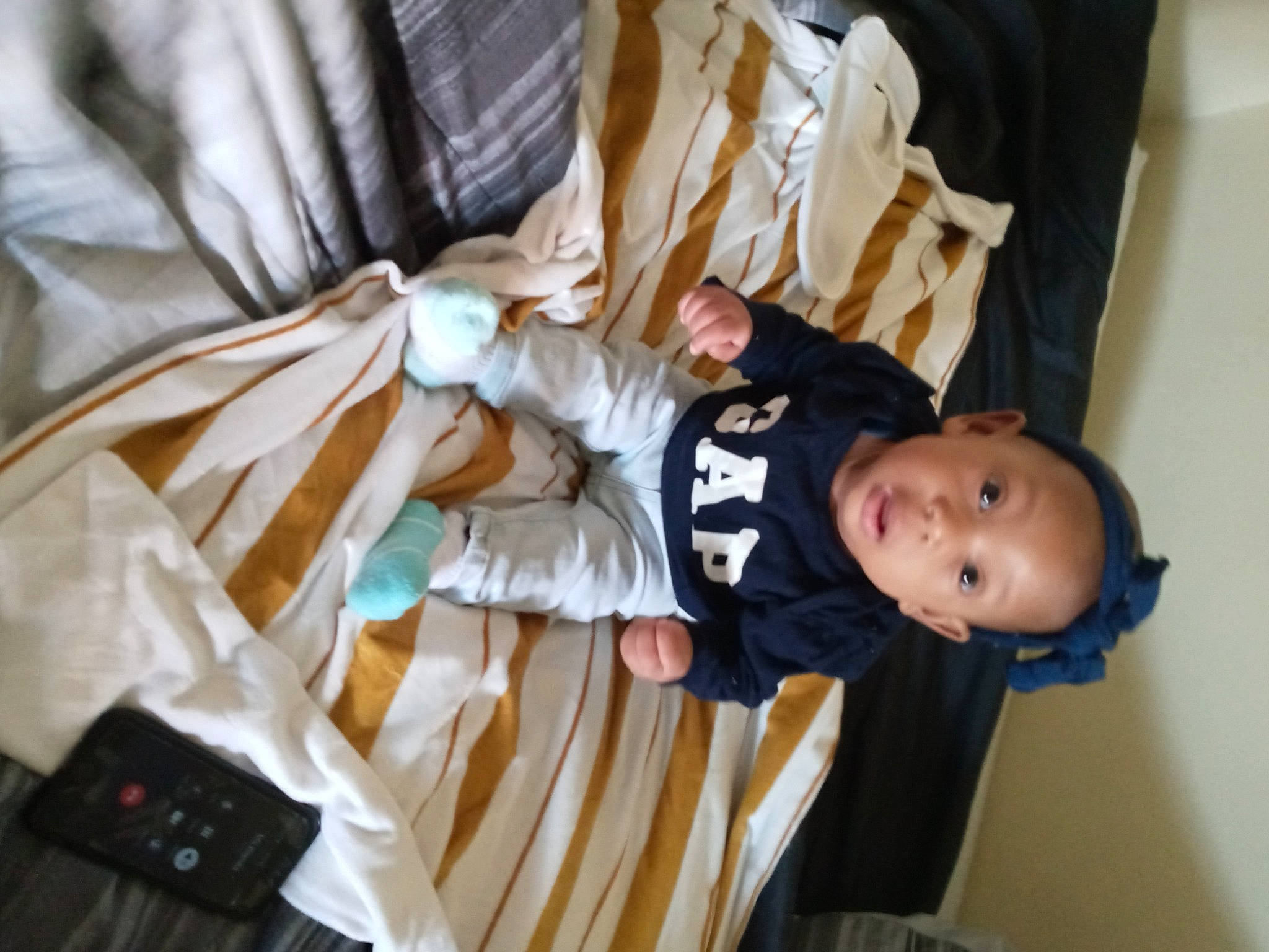 Samiyah is registered to the contest to win money with this photo: baby, baby_products, baby_safety, baby_toddler_clothing, child, comfort, linens, person, room, sitting, sleeve, toddler, wood