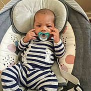 Nymir joined the competition — help win amazing prizes! baby, infant, pacifier, striped_clothing, onesie, baby_seat, cushion, indoor, child, person, young, cute, hands, face, head, comfort, seatbelt, soft, striped, resting