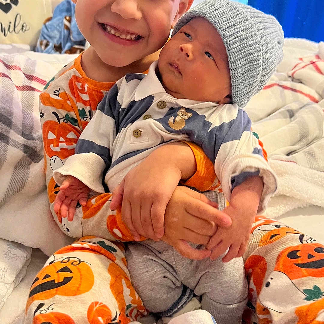 Marco Y Camilo joined the competition — help win amazing prizes! baby, bed, blanket, child, cozy, cute, family, happy, holding, indoor, infant, knit_hat, pajamas, person, portrait, sibling, sleepwear, smiling, toddler, young_child