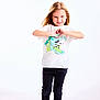 child, girl, standing, white_background, tshirt, mickey_mouse, hand_gesture, heart_shape, black_pants, sandals, smiling, blonde_hair, casual_clothing, studio_photo, full_body, pose, happy, cute, fashion, footwear