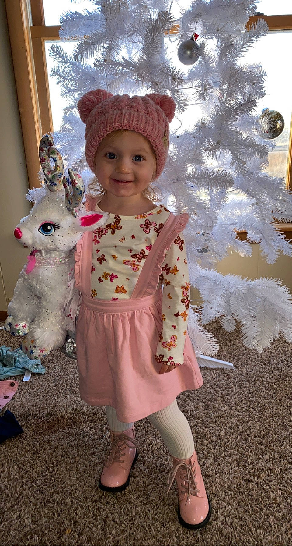 Adilynne joined the competition — help win amazing prizes! baby_toddler_clothing, child, christmas_ornament, christmas_tree, dress, fawn, fun, happy, headgear, headwear, joy, magenta, pattern, person, pink, rabbits_and_hares, skin, sleeve, smile, standing