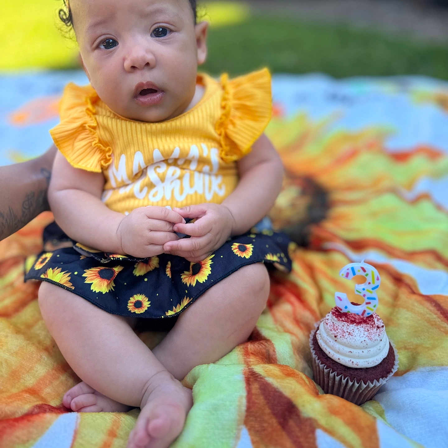 Xaliyah joined the competition — help win amazing prizes! baby, birthday_candle, blanket, celebration, child, cupcake, curly_hair, cute, face, feet, grass, hands, infant, number_3, outdoor, portrait, sitting, skirt, sunflower_pattern, yellow_clothing