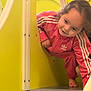 Tayana a rejoint le concours — aidez-le/la à gagner de superbes lots ! child, toddler, pink_tracksuit, adidas, playground, play_structure, slide, peek, smiling, curly_hair, barefoot, indoor_play, yellow_panel, plastic_panel, candid, portrait, playful, crawling, happy, closeup