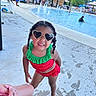 child, girl, swimsuit, sunglasses, heart_shaped, poolside, water, fountains, wet, summer, playful, outdoor, people, concrete, water_splash, braids, smiling, vacation, fun, recreation