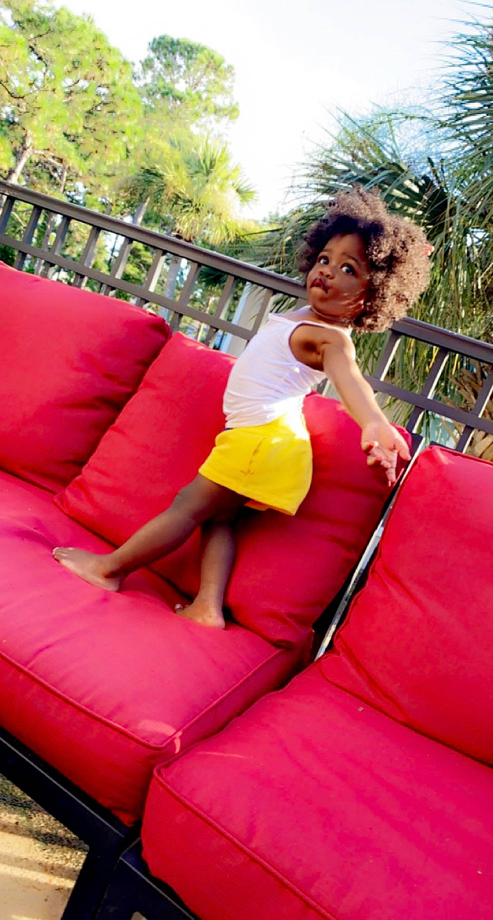 Khloe joined the competition — help win amazing prizes! chute, comfort, couch, fun, grass, happy, human_leg, inflatable, leg, leisure, magenta, outdoor_play_equipment, person, pink, playground, recreation, shorts, sitting, sky, thigh