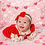 Iris is registered to the contest to win money with this photo: baby, baby_girl, celebration, child, clothing, cute, decorations, fun, happy, headband, heart_pattern, holiday, infant, lying_down, pink_background, portrait, red_bow, smiling, soft_texture, valentines_theme