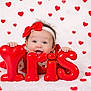 baby, balloon_letters, celebration, child, closeup, cute, happy, headband, hearts, holiday, indoor, infant, joyful, love_theme, playful, portrait, red_bow, red_color, smiling, soft_background