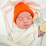 Ellie Hazel is registered to the contest to win money with this photo: baby, sleeping, orange_hat, blanket, plush_toy, elephant_toy, soft_toy, infant, cozy, white_background, cute, child, peaceful, knit_hat, resting, newborn, wrapped, adorable, comfort, portrait