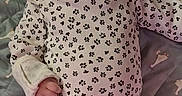 Kateri is registered to the contest to win money with this photo: baby, infant, child, portrait, lying_down, bed, quilt, headband, bow, floral_clothing, dress, socks, indoors, face, eyes, looking_at_camera, patterned_fabric, textile, cute, family_photo
