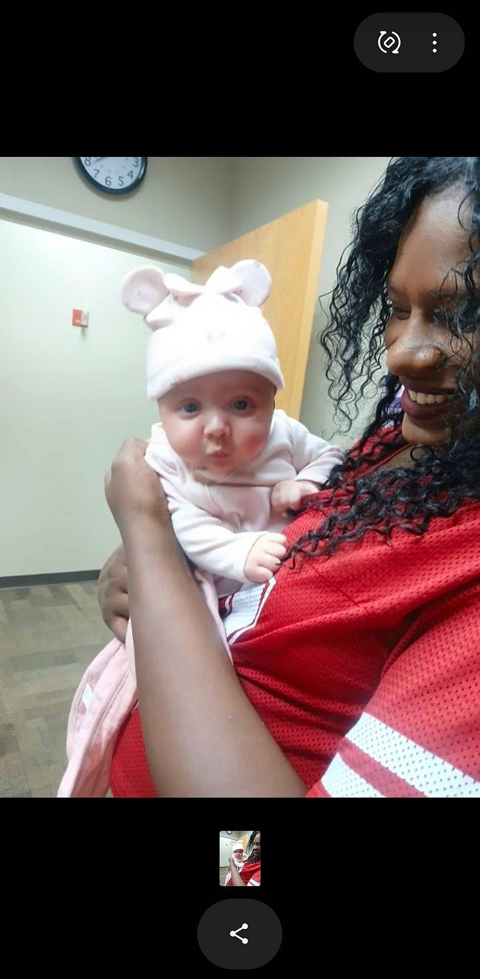 Kateri joined the competition — help win amazing prizes! adult, baby, bunny_hat, caregiver, cuddling, doorway, family, holding, human, indoor, infant, photograph, pink_clothing, portrait, red_shirt, smiling, tiled_floor, wall_clock, wide_eyed, woman