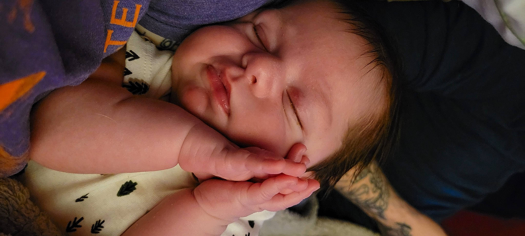 Malcolm is registered to the contest to win money with this photo: arm, baby, cheek, chin, comfort, eye, eyebrow, eyelash, finger, gesture, hand, happy, lip, mouth, nail, nose, person, skin, smile, thumb