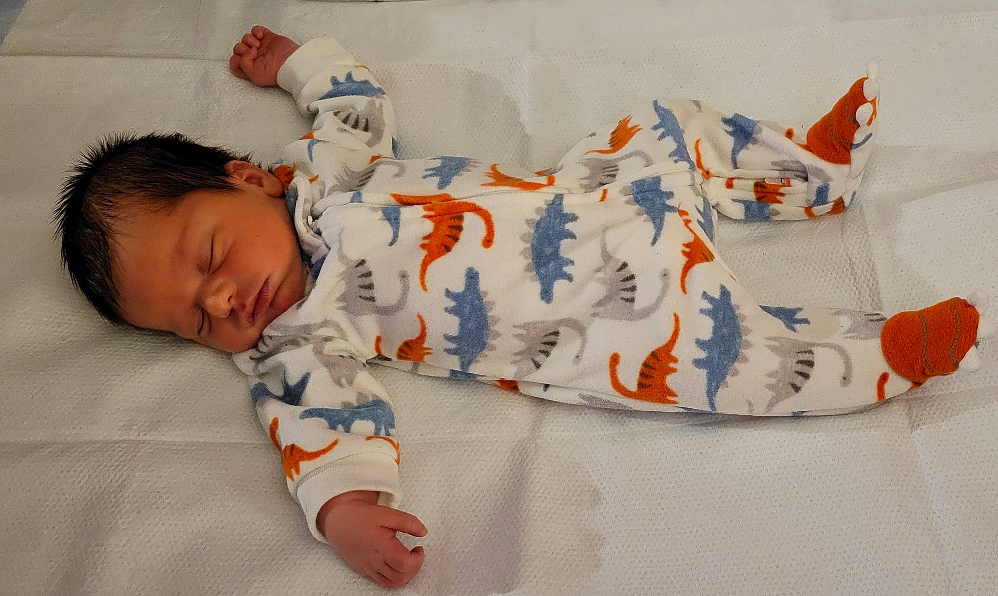 Malcolm is registered to the contest to win money with this photo: art, baby, baby_products, baby_sleeping, baby_toddler_clothing, bed_sheet, bedding, bedtime, carmine, child, comfort, linens, pattern, person, product, room, sitting, sleeve, t_shirt, textile