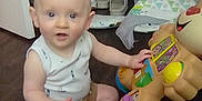 Sterling joined the competition — help win amazing prizes! baby, bag, child, clothing, colorful, curious, cute, floor, home, household, indoor, infant, laundry_basket, lion_toy, person, play, shoes, sitting, toy, wheels