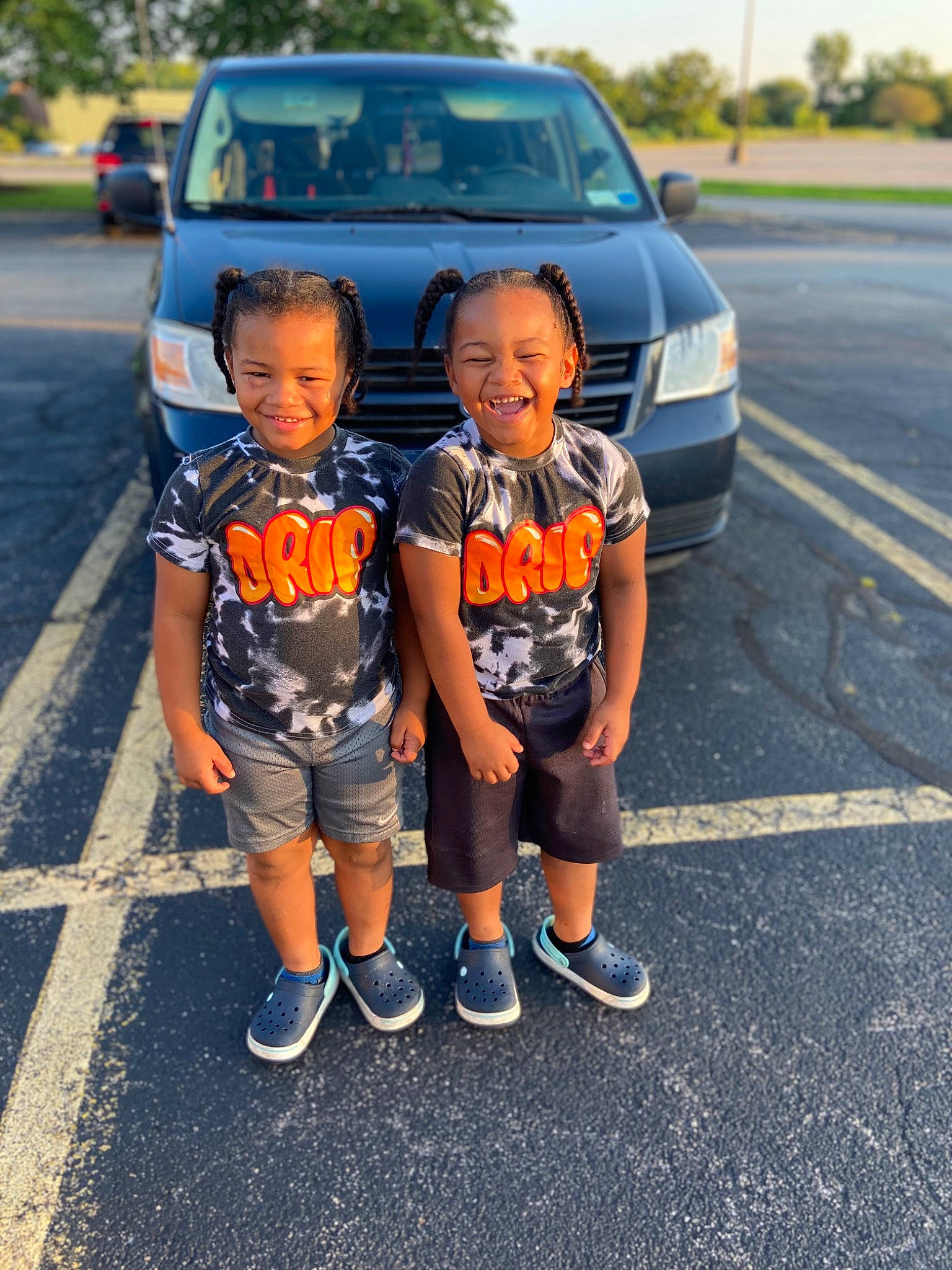 Rondell And Rockell joined the competition — help win amazing prizes! asphalt, automotive_exterior, automotive_lighting, automotive_tire, bumper, car, clothing, face, footwear, hood, joy, land_vehicle, motor_vehicle, person, plant, shoe, shorts, t_shirt, toddler, tree