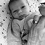 Tony a rejoint le concours — aidez-le/la à gagner de superbes lots ! baby, newborn, infant, hand, foot, knitted_sweater, blanket, pattern, cartoon_faces, black_and_white, portrait, closeup, person, skin, ring, anchor_symbol, gentle_touch, lying_down, soft_texture, tender_moment