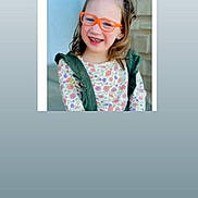 Neveah is registered to the contest to win money with this photo: bow, casual, child, childhood, cute, eyewear, face, fashion, floral_clothing, girl, glasses, hair_accessory, happy, indoor, orange_glasses, person, portrait, smiling, vest, young