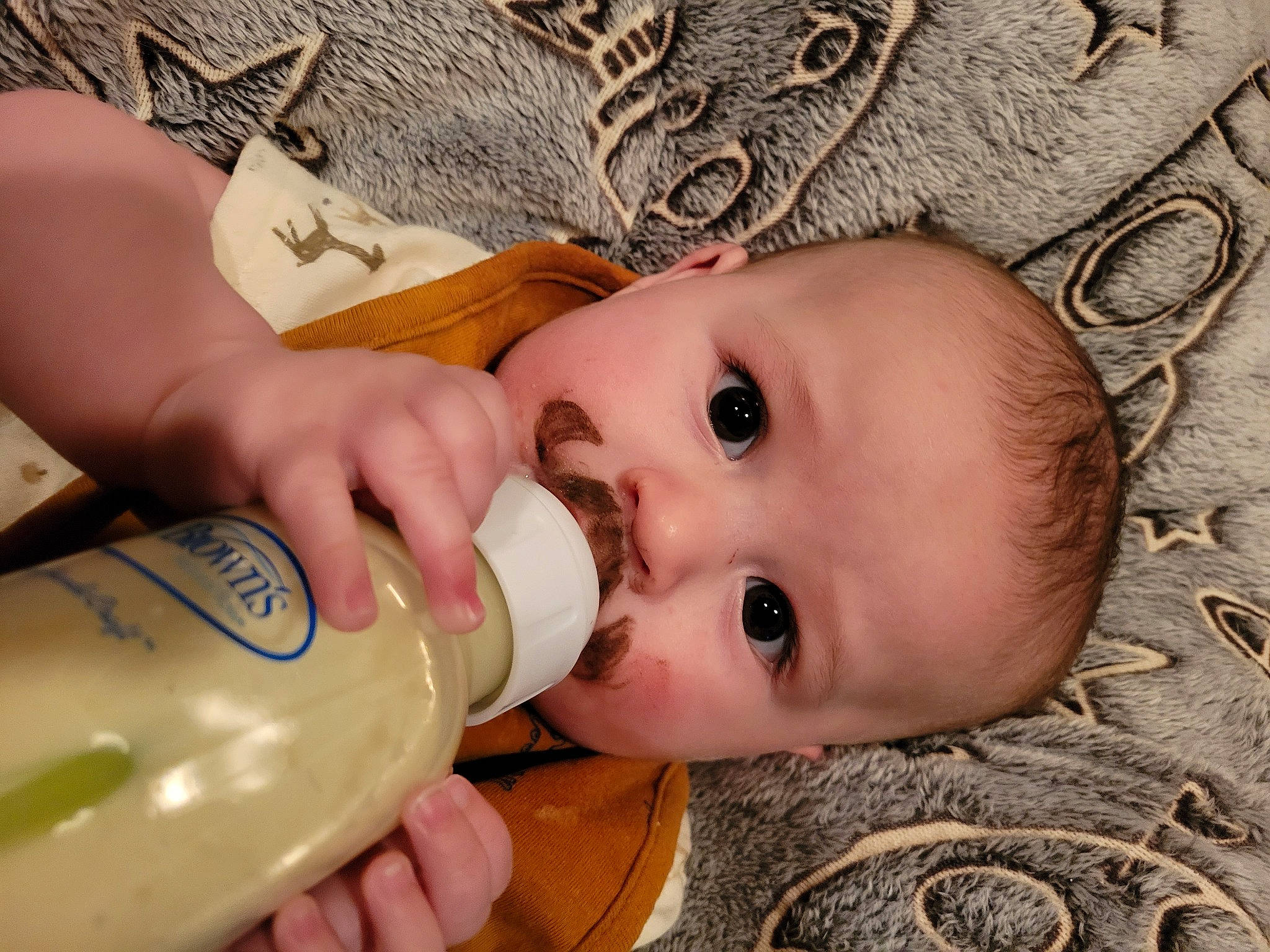George joined the competition — help win amazing prizes! baby, baby_bottle, bottle, cheek, drinkware, eye, eyebrow, eyelash, face, hand, head, iris, lip, mouth, nose, organ, person, plastic_bottle, product, skin